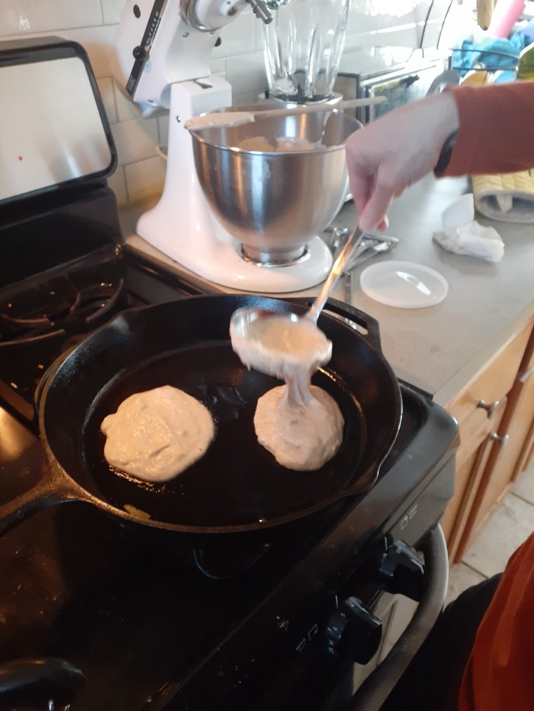 Cooking whole wheat pancakes, pouring on to skillet