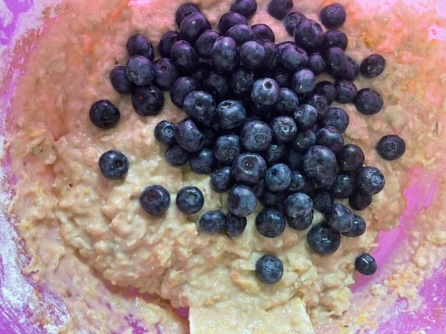 Fold blueberries into oatmeal muffin mixture.